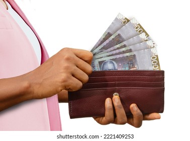 Fair Female Hand Holding Brown Purse With Haitian Gourge Notes, Hand Removing Money Out Of Purse Isolated On White Background