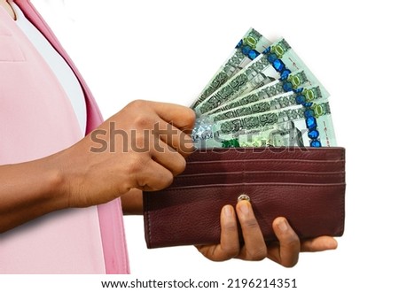 fair Female Hand Holding brown Purse With Libyan dinar notes, hand removing money out of purse isolated on white background Сток-фото © 