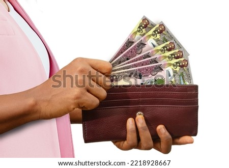 fair Female Hand Holding brown Purse With Iraqi dinar notes, hand removing money out of purse isolated on white background Stock foto © 