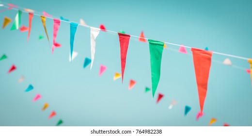 Fair Flag Blur Bunting Background Hanging On Blue Sky For Fun Festa Party Event, Summer Holiday Farm Feast Celebration, Carnival Festival Event, Park Or Street Fiesta Design Decoration Element