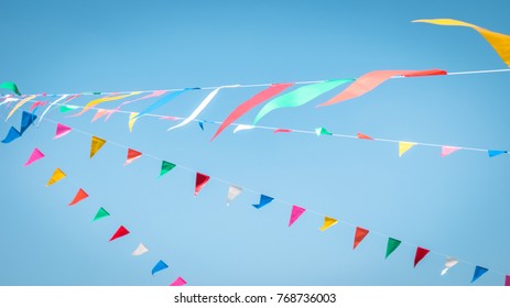 Fair Flag Blur Bunting Background Hanging On Blue Sky For Fun Festa Party Event, Summer Holiday Farm Feast Celebration, Carnival Festival Event, Park Or Street Fiesta Design Decoration Element