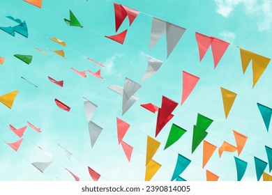 Fair flag bunting colorful background hanging on blue sky for fun fiesta party event, summer holiday farm feast celebration, carnival festival event, park or street festa design decoration - Powered by Shutterstock