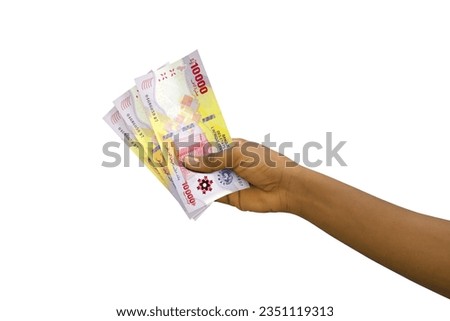 Fair hand holding 3D rendered 10000 Central African CFA franc notes isolated on white background