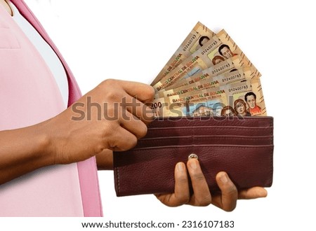 fair Hand Holding brown Purse With Bolivian boliviano notes, hand removing money out of purse isolated on white background