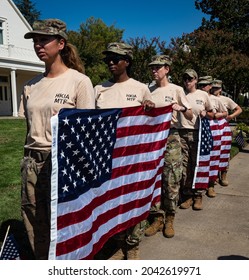 FAIR OAKS, CA, U.S.A. - SEPT. 16, 2021: A Group Of Women With Hamid Karzai International Airport (HKIA) Military Treatment Facility (MTF) Uniforms Hold U.S. Flags As Sgt. Nicole Gee's Hearse Arrives.