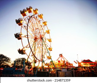 a fair ride during dusk on a warm summer evening - Shutterstock ID 214871359