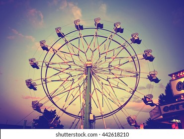  a fair ride during dusk on a warm summer evening toned with a retro vintage instagram filter effect 