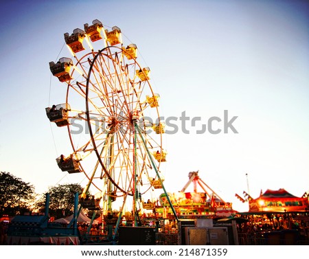 a fair ride during dusk on a warm summer evening