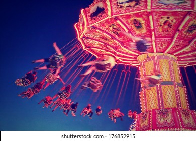  a fair ride shot with a long exposure at night done with a retro vintage instagram filter 