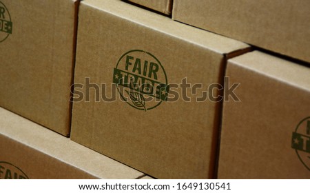 Fair Trade stamp printed on cardboard box. Ethical business, green trade, sustainable economy and environmental care concept.