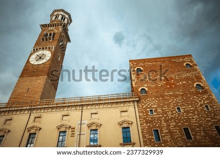 Fair Verona concept. The Torre dei Lamberti - high tower in the old city centre. Dramatic cloudy sky. Outdoor shot