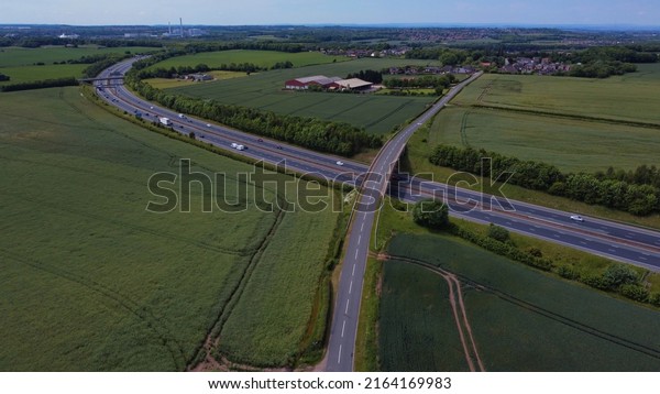 Fairburn, North Yorkshire,\
England, Britain, June 2022, Aerial view of road bridge crossing\
A1M motorway