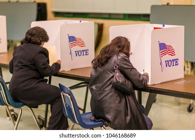 FAIRFAX COUNTY, VIRGINIA, USA - NOVEMBER 4, 2008: Women Voters At Polls During Presidential Election, Paper Ballots.