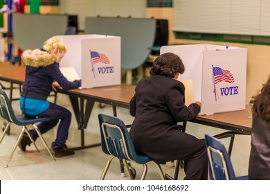 FAIRFAX COUNTY, VIRGINIA, USA - NOVEMBER 4, 2008: Women voters at polls during presidential election, paper ballots.