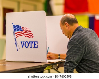FAIRFAX COUNTY, VIRGINIA, USA - NOVEMBER 4, 2008: Voter at polls during presidential election, using paper ballots.