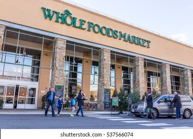 Fairfax, USA - December 3, 2016: Whole Foods Market store facade with customers crossing street