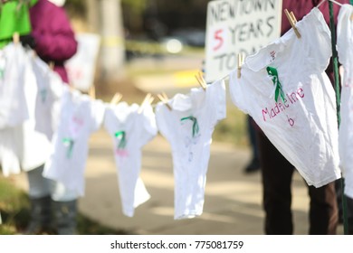 Fairfax, VA - December 14, 2017: T-shirts With The Names Of The Victims Of The Sandy Hook Elementary School Massacre Blow In The Wind During A Vigil Held Outside Of The National Rifle Association.