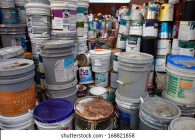 FAIRFAX, VA - DECEMBER 5: A collection of different sizes paint cans, glue buckets, mastic and toxic and hazardous material stacked at a recycling facility on December 5, 2013 in Fairfax, VA.