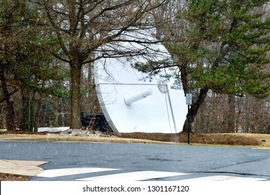 Fairfax, Virginia, USA - January 29, 2019: Light Snow Falls Onto A Large Satellite Dish At George Mason University’s Main Campus.