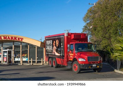 Fairfield, California, USA - February 4 2021: Delivery truck for Conor McGregor's Proper Twelve whiskey unloads product at a California market, large portrait of Conor McGregor on truck panel