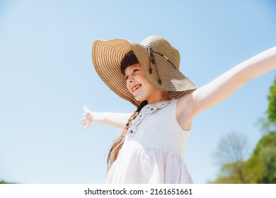 fair-haired little girl in a straw hat on the beach. summer