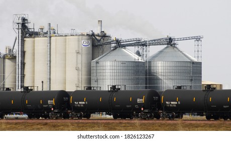 Fairmont, Minnesota, Martin County, Southern Minnesota, USA,  A string of ethanol railroad tank cars await loading at an industrial park, ethanol production facility. Corn and soy bean storage silos.