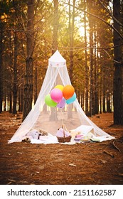 Fairy Castle In The Woods. Shot Of A Tent Made For A Childrens Birthday Party Filled With Balloons And Presents Outside In The Woods.