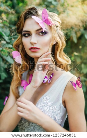 fairy girl Dryad with butterflies in nature in the forest