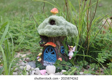 Fairy House With Swing In A Natural Backyard Rock Garden Overgrown With Spotted Spurge