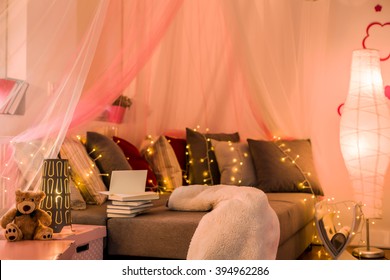 Fairy lights and baldachin in teen bedroom - Powered by Shutterstock