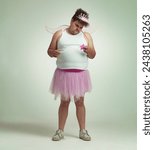 Fairy, man and studio portrait for magic and isolated, sad male person with wings and pretend costume. Pink Cosplay, depressed and mature plus size model, dress up or role play on white background