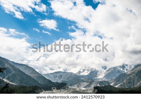 The Fairy Meadows Nanga Parbat mountains with a cloudy blue sky in the background, Pakistan