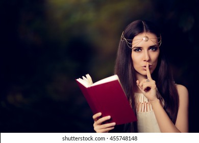 Fairy Princess Girl Reading Mysterious Secret Book - Magic portrait of fairytale goddess woman in nature

