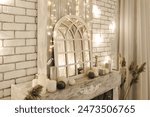 Fairy tale mirror with arched frame, surrounded by fairy lights and candles, set against a white brick fireplace. The warm light and wooden elements add magic and coziness to the interior