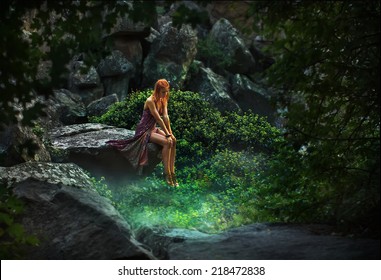 Fairy tale. Princess in a mystical garden pensively looking down