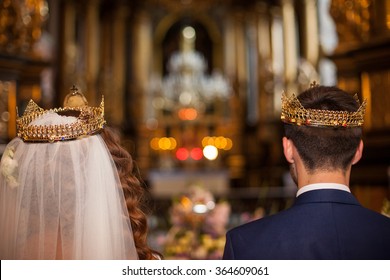 Fairytale Couple, Bride And Groom In Crowns During Wedding Ceremony In Church