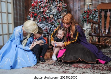Fairy-tale princesses in costumes of Anna and Elsa with children