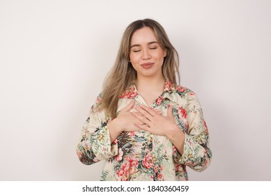 Faithful Woman Closes Eyes And Keeps Hands On Chest Near Heart, Shows Her Kindness Or Favour, Expresses Sincere Emotions, Being Kind Hearted And Honest. Body Language And Real Feelings Concept