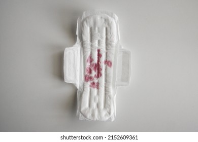 Fake Blood. Pomegranate Juice. Used Female Pad On White Background. Gasket For Women In Ministry. Bloody Woman Strip. Ministrative Blood. Blood On Female Pad