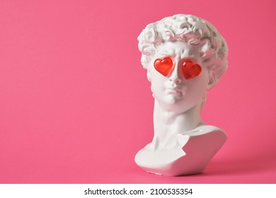 fake bust of david with red glass hearts on the eyes, love concept, valentine's day congratulations