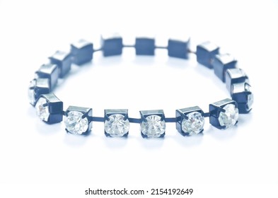 fake diamond bracelet with black rope arranging on white background
 