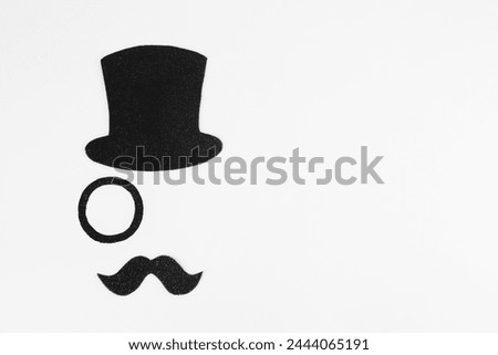 Fake mustache, hat and monocle on white background, top view. Space for text