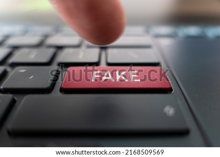 Fake News concept. Red button with Fake News words on the keyboard close-up