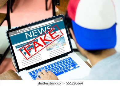 Fake news, HOAX concept.Young man using laptop or computers