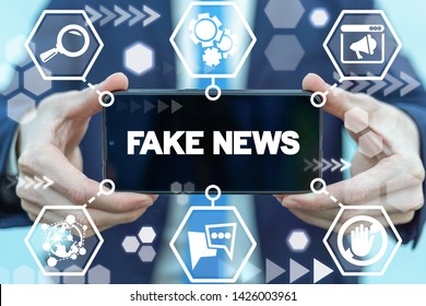 Fake news media disinformation internet technology on smartphone in man hands. - Shutterstock ID 1426003961