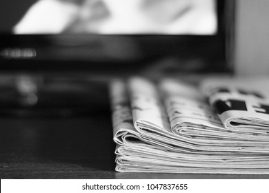 Fake News - Newspapers On The Table Next To TV. Daily Papers And Television, Concept For Information And Communication