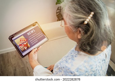 Fake News Online On Laptop : Elderly Woman Looks At Political News Headlines About Coronavirus Vaccine Imports. (Covid-19) That Is Not Enough To Meet The Needs Of The People And There Are Protests