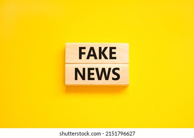 Fake News Symbol. Wooden Blocks With Concept Words Fake News On Beautiful Yellow Background. Business Media And Fake News Concept. Copy Space.