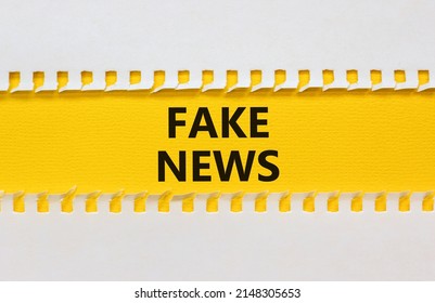 Fake News Symbol. Yellow And White Paper With Concept Words Fake News On Beautiful White Background. Business Media And Fake News Concept. Copy Space.