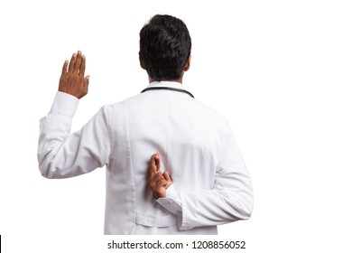 Fake Oath Made By Indian Doctor With Fingers Crossed Behind Back And Raised Palm Isolated On White Background